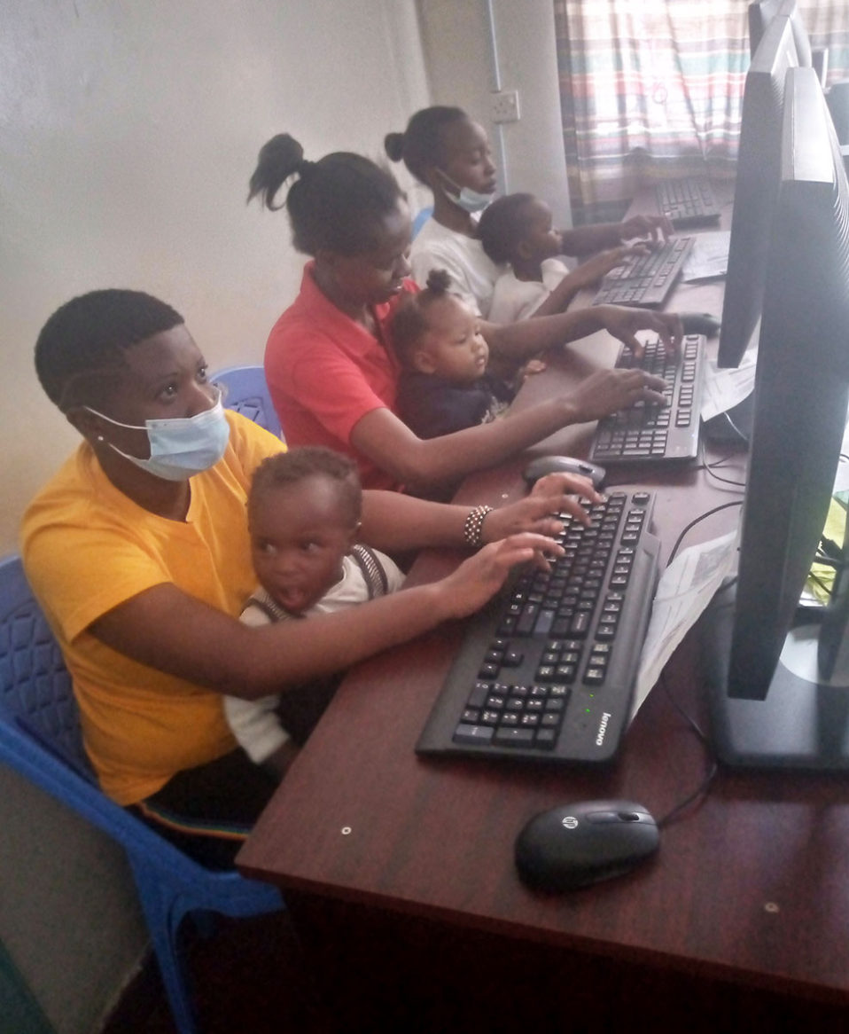 Teens at computers with babies