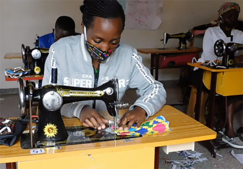 Woman learning to sew at the Women Like Us Center in Nakuru, Kenya Woman learning to sew at the Women Like Us Center in Nakuru, Kenya